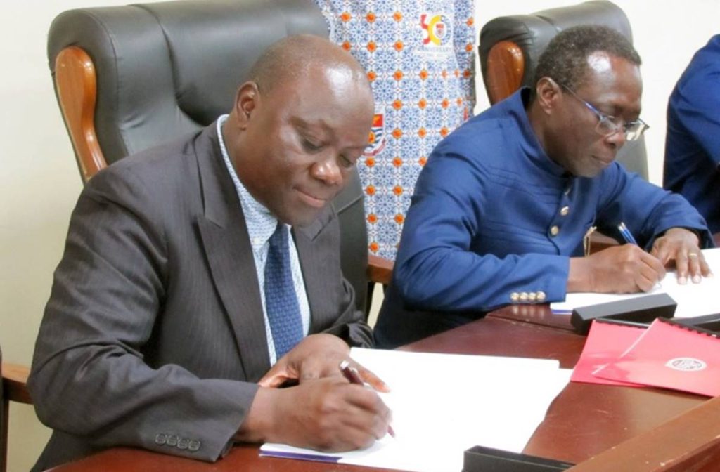 CBIS Dean Matthew W. Guah (left) signs the MOU with Johnson Nyarko Boampong, vice chancellor at the University of Cape Coast in Ghana.